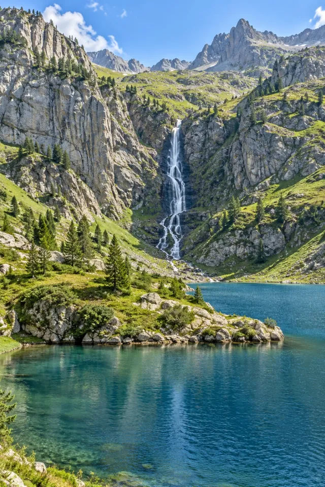 Waterfall above a Mountain Valley Lake