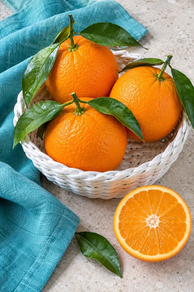 Oranges in a White Basket