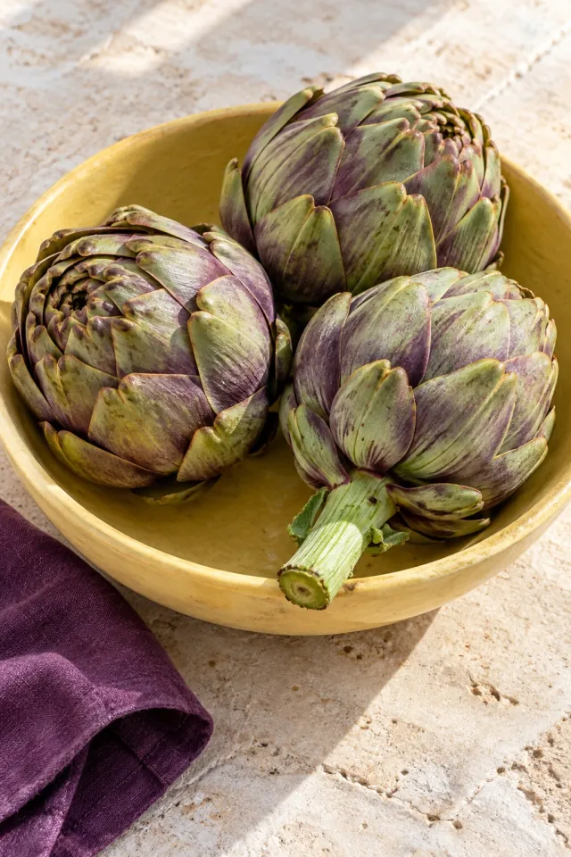 Purple Artichokes in a Ceramic Bowl